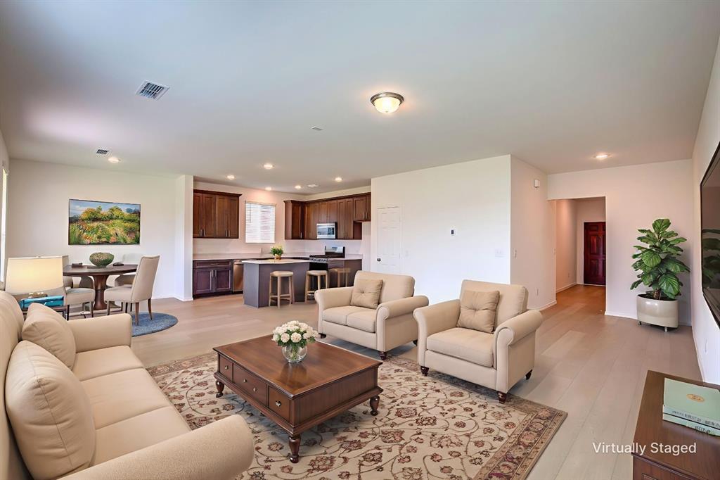 1426 Tramore Way Princeton, TX 75407 - Photo 5 of 20 a living room with furniture kitchen view and a potted plant
