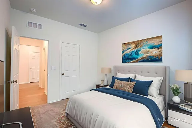 a bedroom with a bed and a painting on the wall