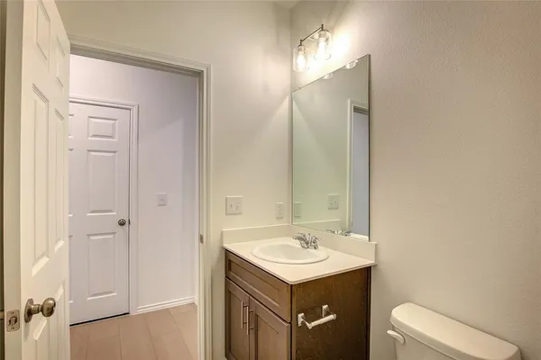 a bathroom with a sink a toilet and mirror