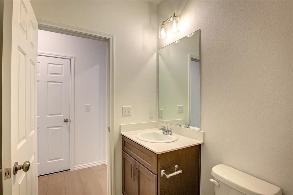 1426 Tramore Way Princeton, TX 75407 - Photo 8 of 20 a bathroom with a sink a toilet and mirror