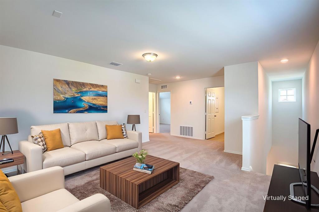 1426 Tramore Way Princeton, TX 75407 - Photo 9 of 20 a living room with furniture a rug and a flat screen tv