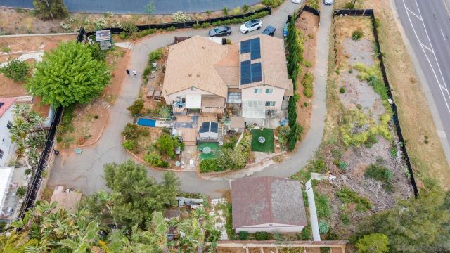 an aerial view of residential house with outdoor space and swimming pool
