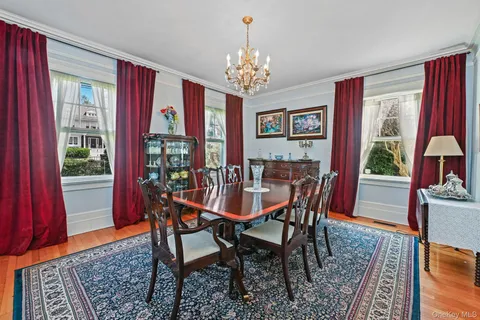 a dining room with furniture a window and a chandelier