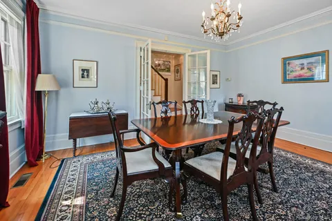 a dining room with furniture and wooden floor
