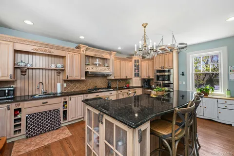 a kitchen with a table chairs stove and cabinets