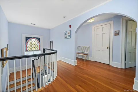 a view of an entryway with wooden floor
