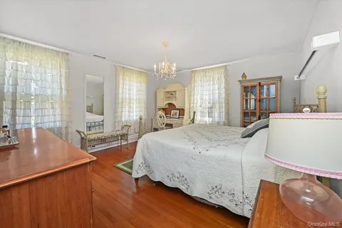 a spacious bedroom with a bed and a large window