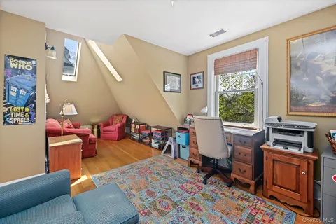 a living room with furniture a rug and a window