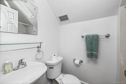 a white toilet sitting next to a bathroom sink