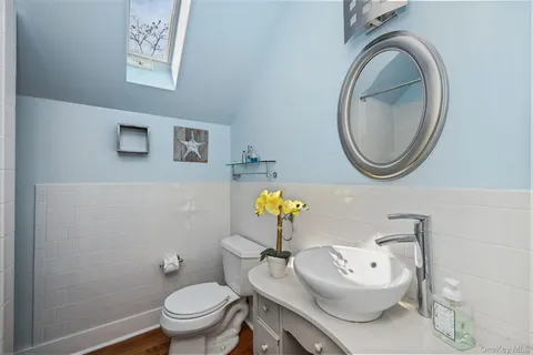 a bathroom with a toilet a sink and mirror
