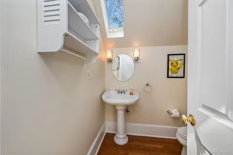 a bathroom with a sink mirror and toilet