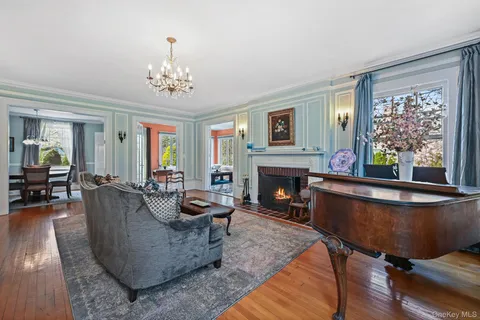 a living room with furniture a fireplace and a table