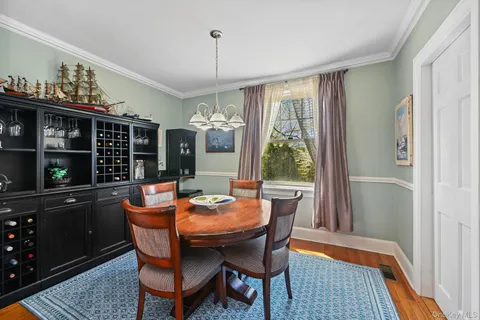 a dining room with furniture a chandelier and window