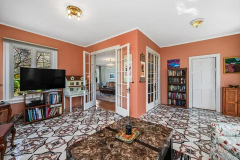 a bedroom with furniture and a flat screen tv