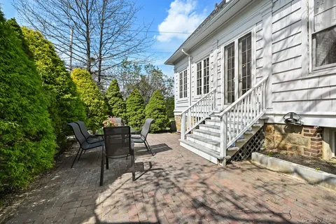 a view of a chair and table in backyard
