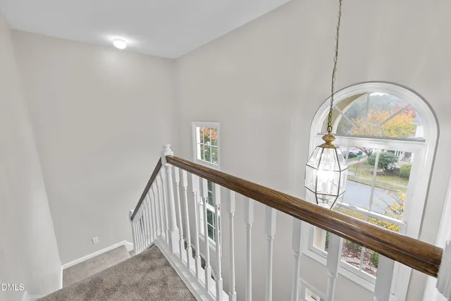 a kitchen with cabinets stainless steel appliances and wooden floor