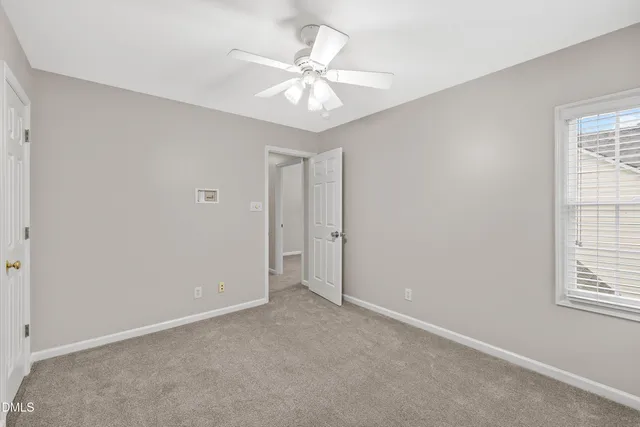 a bathroom with a granite countertop sink a light fixture and a mirror