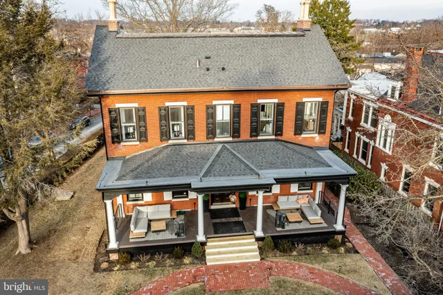 an aerial view of a house with a yard