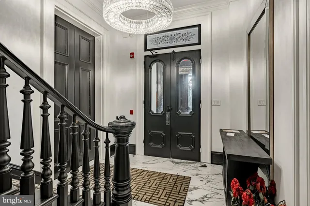 a view of hallway with stairs and wooden floor