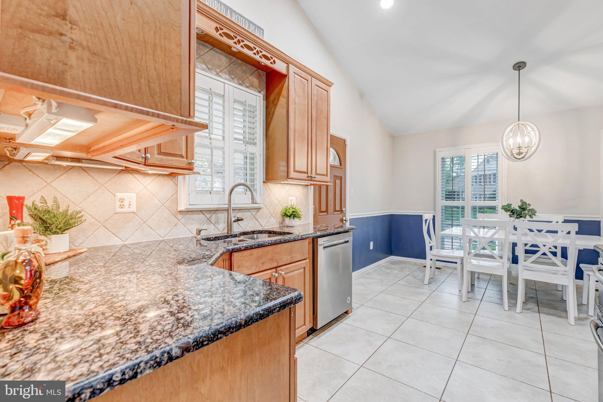 8619 Nanlee Drive Springfield, VA 22152 - Photo 12 of 73 a kitchen with stainless steel appliances granite countertop a sink and a wooden cabinets