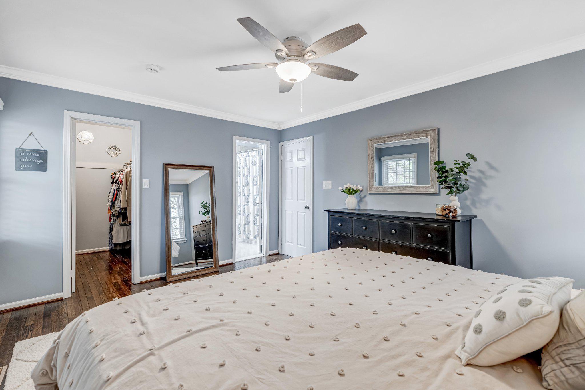 8619 Nanlee Drive Springfield, VA 22152 - Photo 28 of 73 a bedroom with a large bed and a chandelier