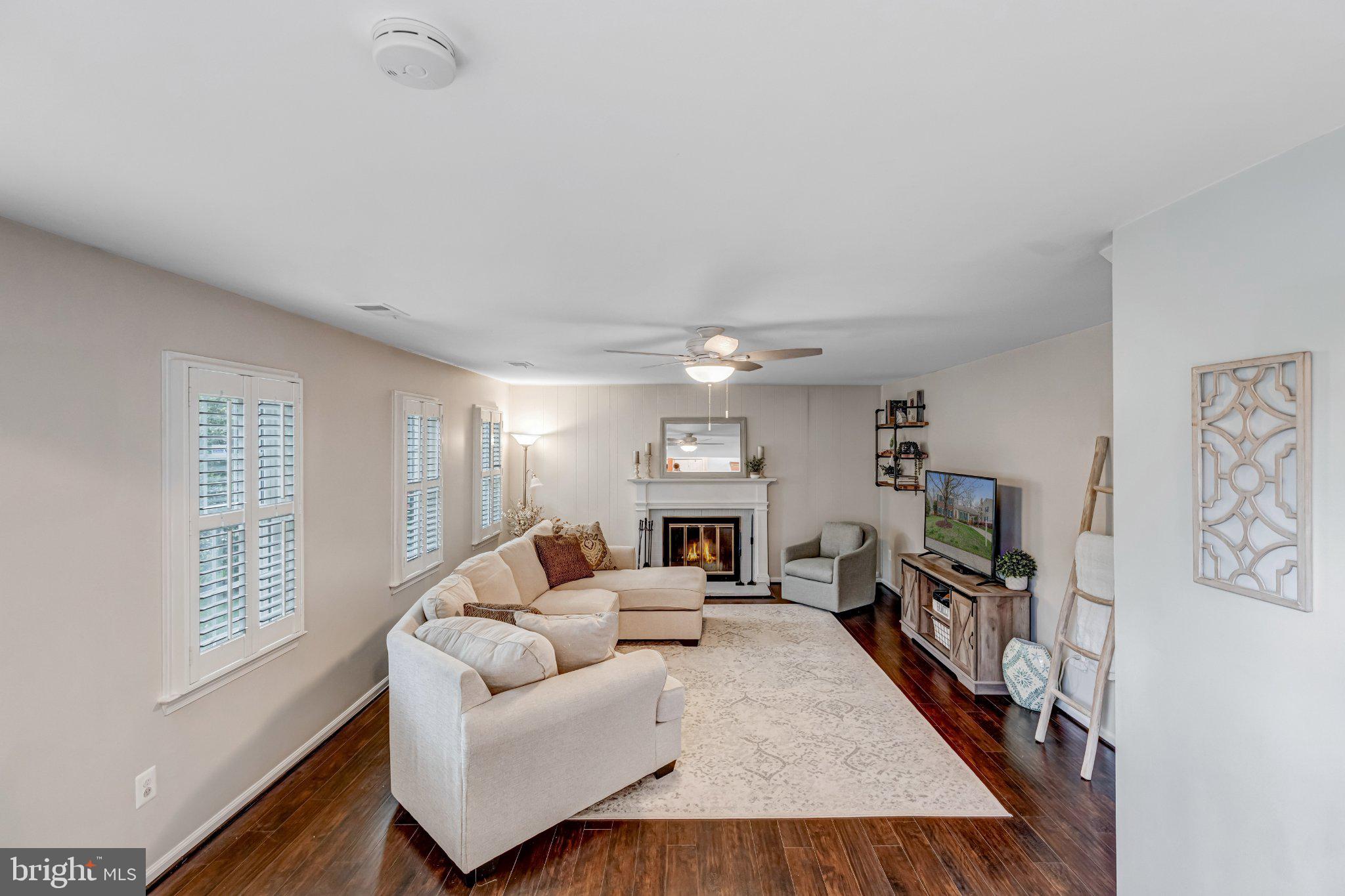 8619 Nanlee Drive Springfield, VA 22152 - Photo 36 of 73 a living room with furniture and a flat screen tv