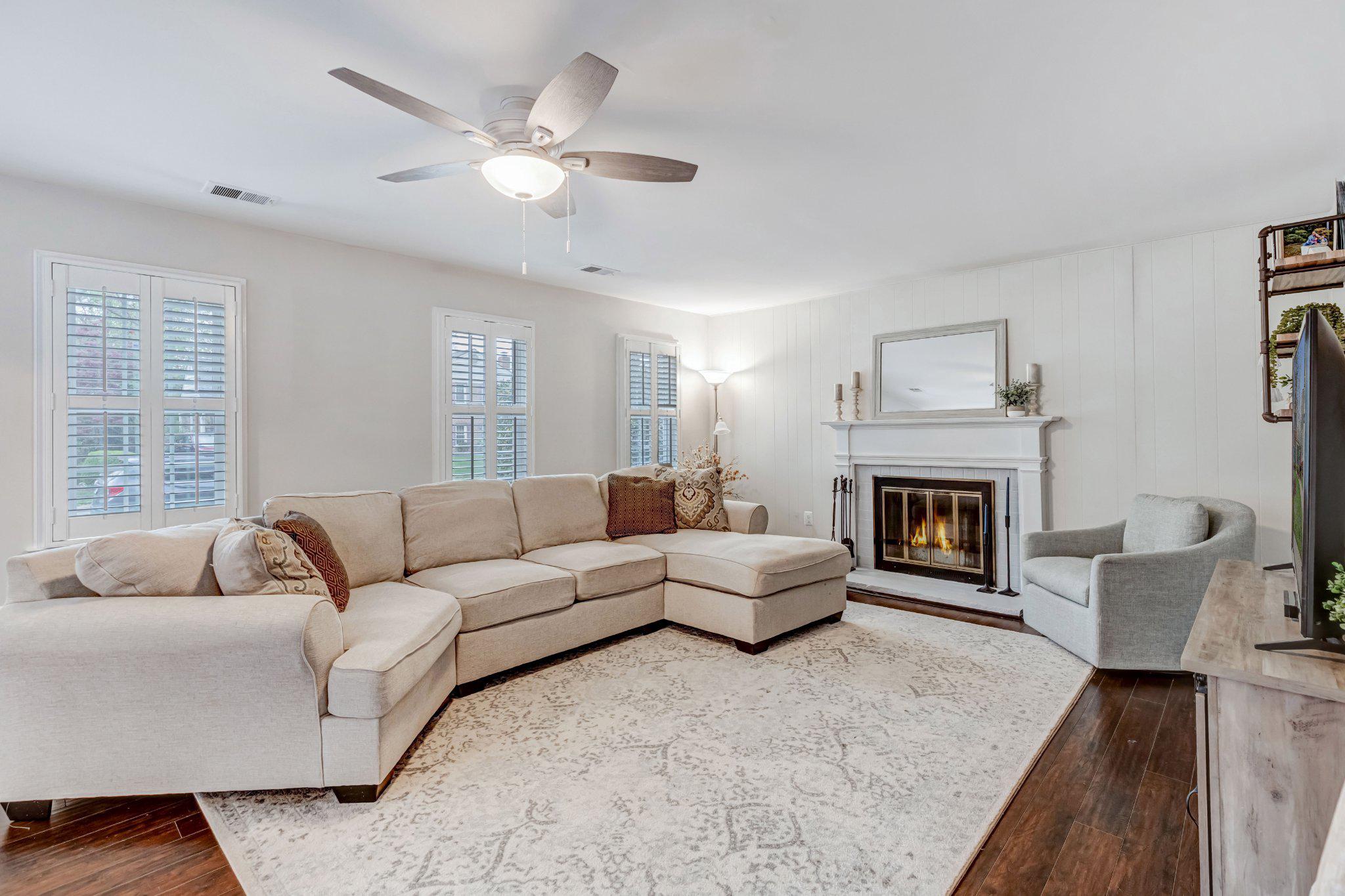 8619 Nanlee Drive Springfield, VA 22152 - Photo 37 of 73 a living room with furniture and a fireplace