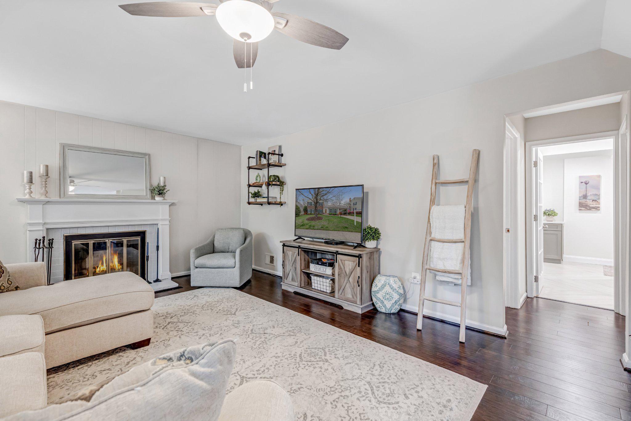 8619 Nanlee Drive Springfield, VA 22152 - Photo 38 of 73 a living room with furniture and a fireplace