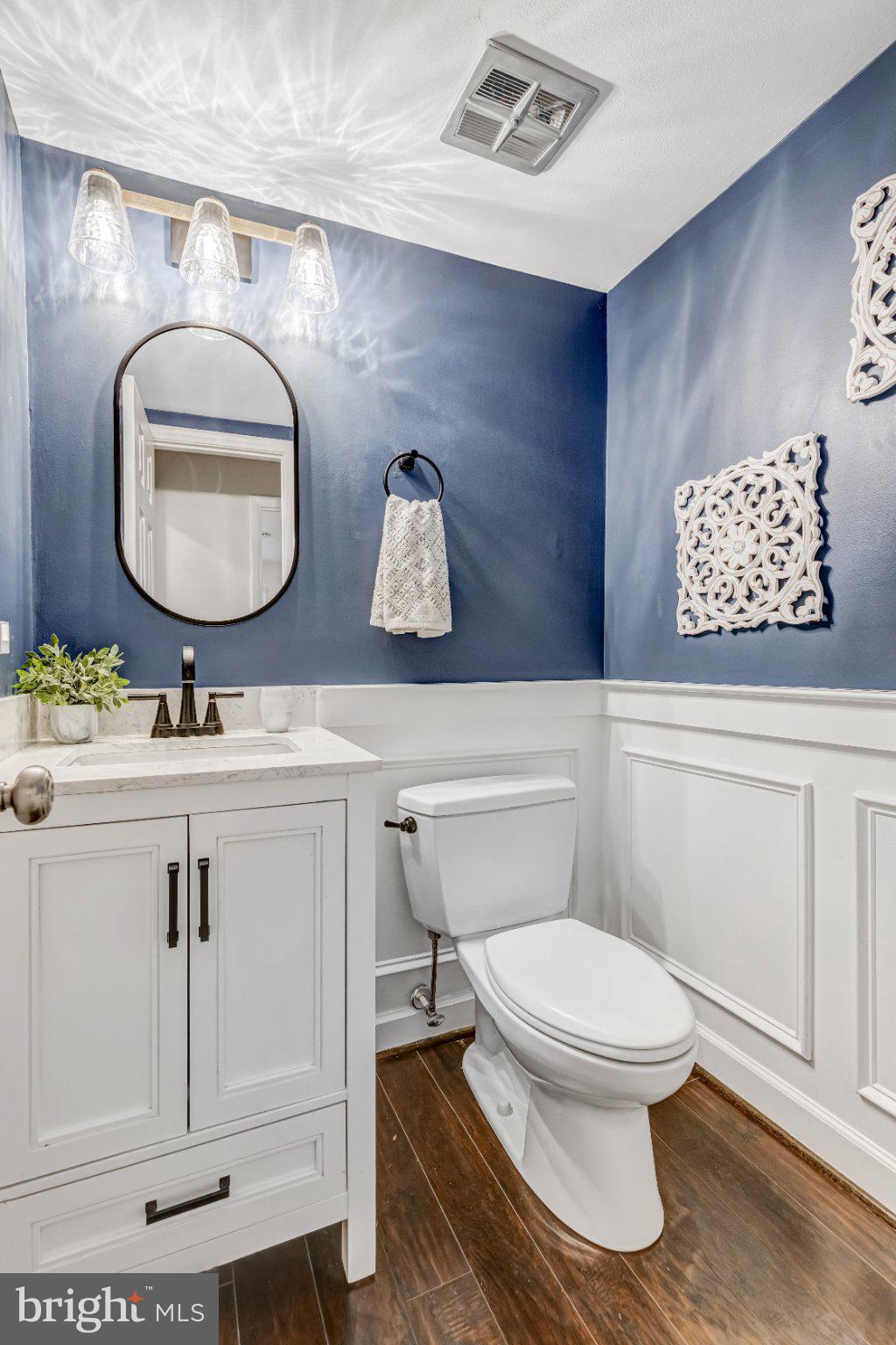 8619 Nanlee Drive Springfield, VA 22152 - Photo 42 of 73 a bathroom with a toilet a sink and mirror