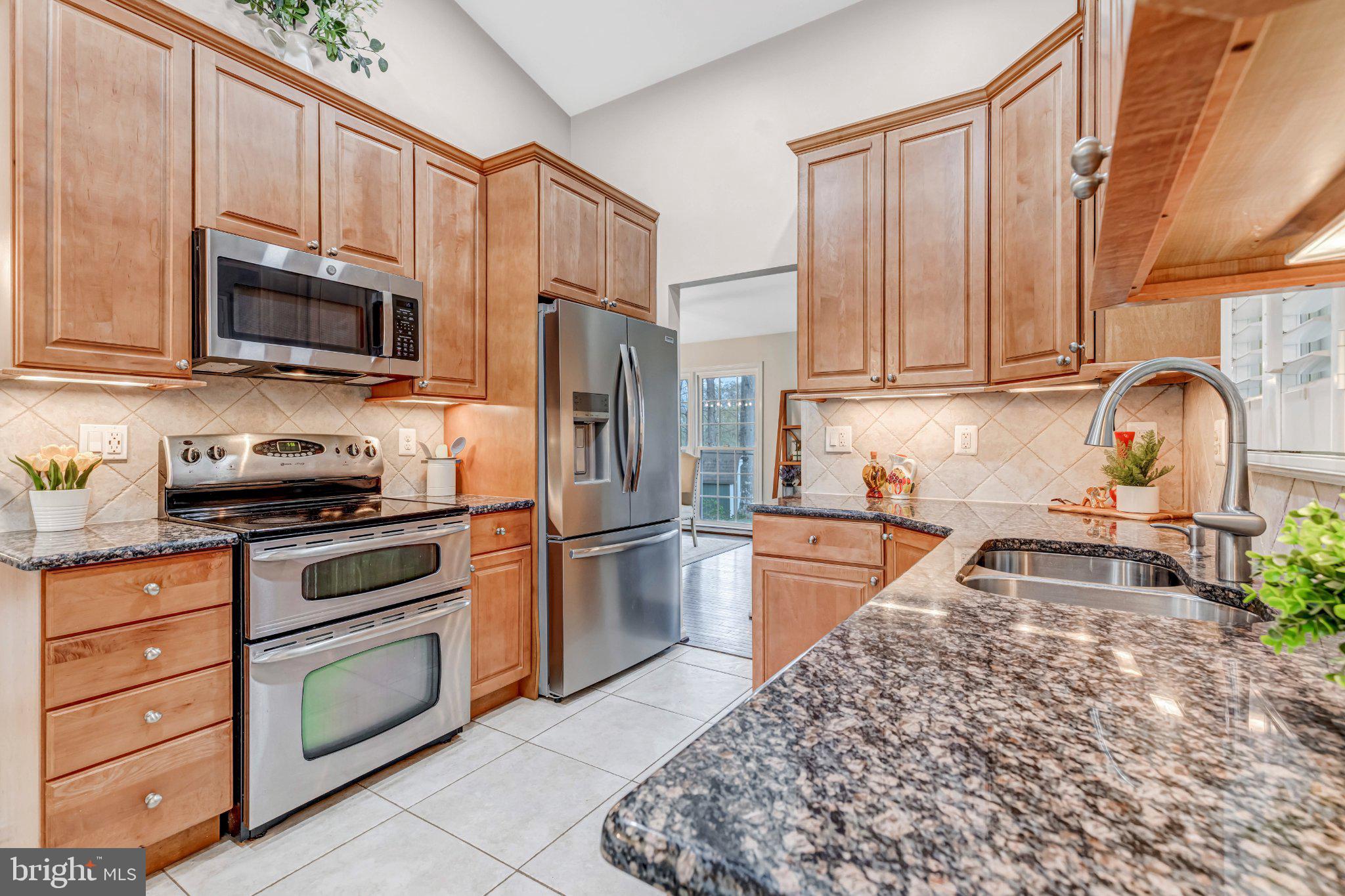 8619 Nanlee Drive Springfield, VA 22152 - Photo 10 of 73 a kitchen with stainless steel appliances granite countertop a stove a sink and a microwave