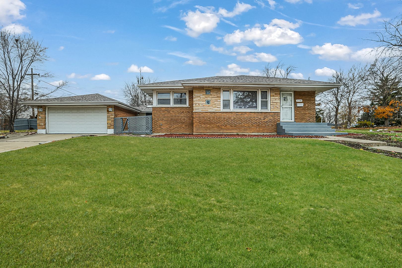 a front view of house with yard and green space