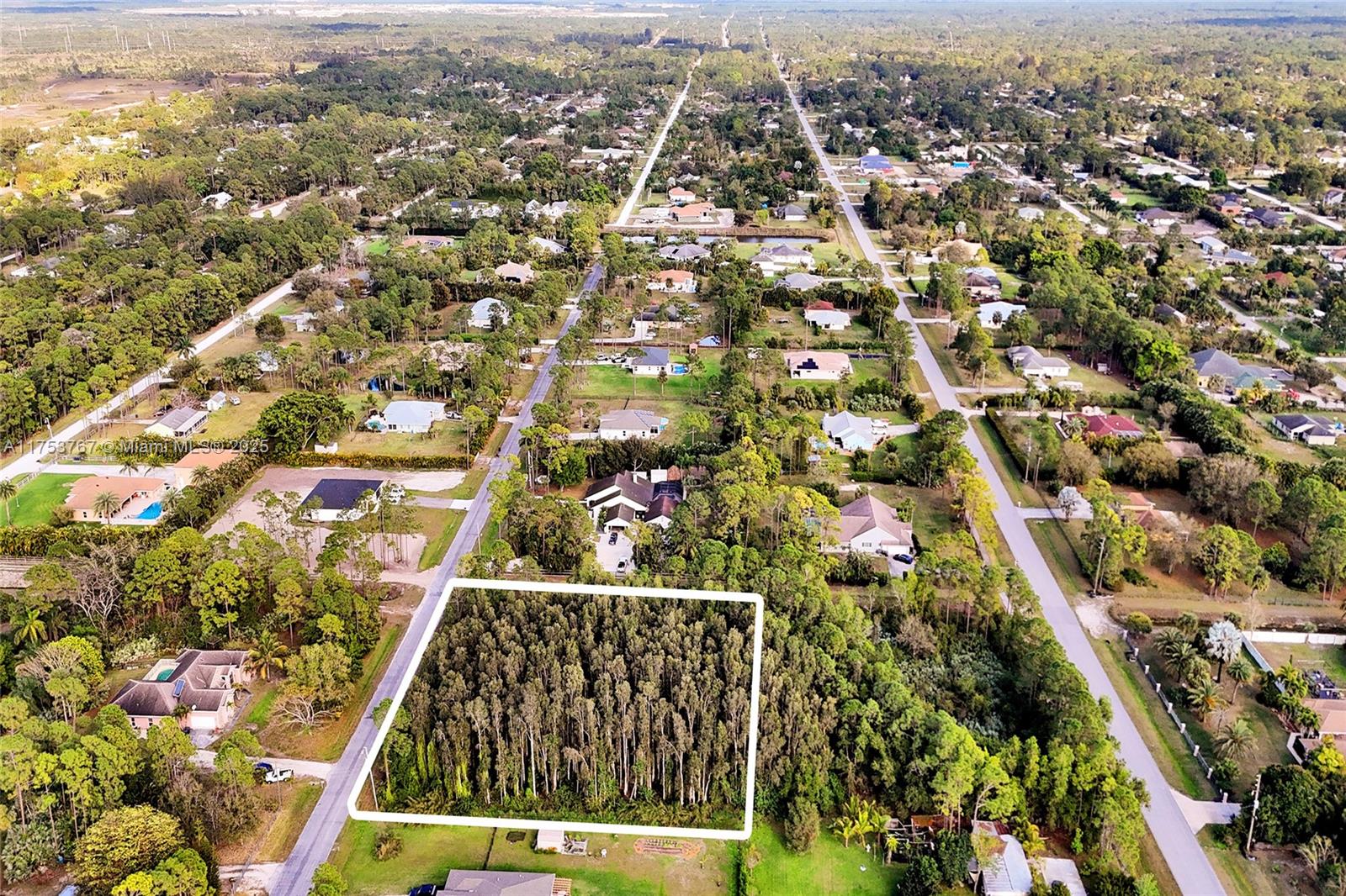 17277 Hamlin Boulevard Loxahatchee, FL 33470 - Photo 7 of 16 an aerial view of residential houses with city view