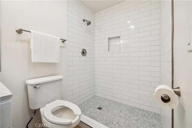 a bathroom with a toilet and a shower