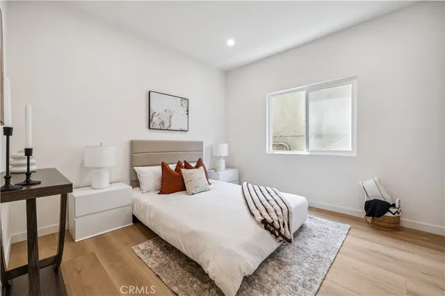 a bedroom with a bed and wooden floor