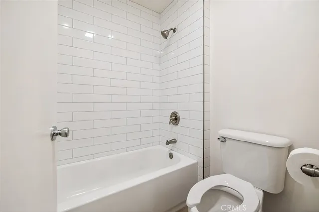 a bathroom with a toilet and a bathtub