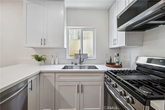 a kitchen with a sink stove and cabinets