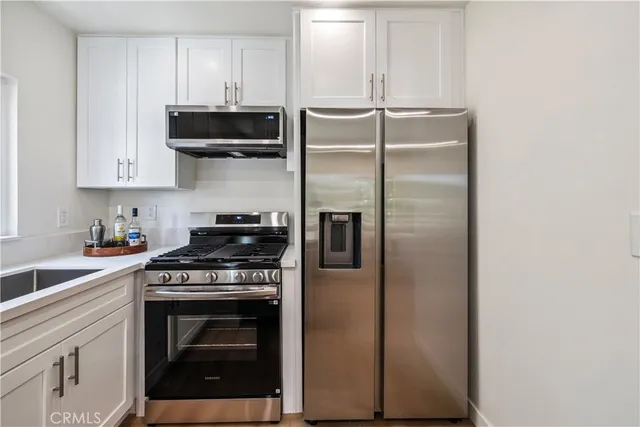 a kitchen with stainless steel appliances granite countertop a stove and a refrigerator