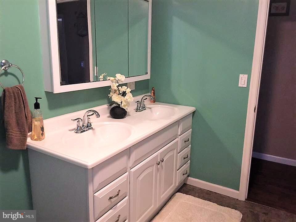 11705 Stoneleigh Road La Vale, MD 21502 - Photo 9 of 13 a bathroom with a sink and a mirror