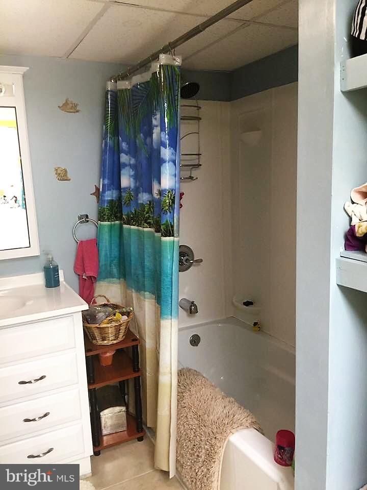 11705 Stoneleigh Road La Vale, MD 21502 - Photo 10 of 13 a bathroom with a bath tub and a shower