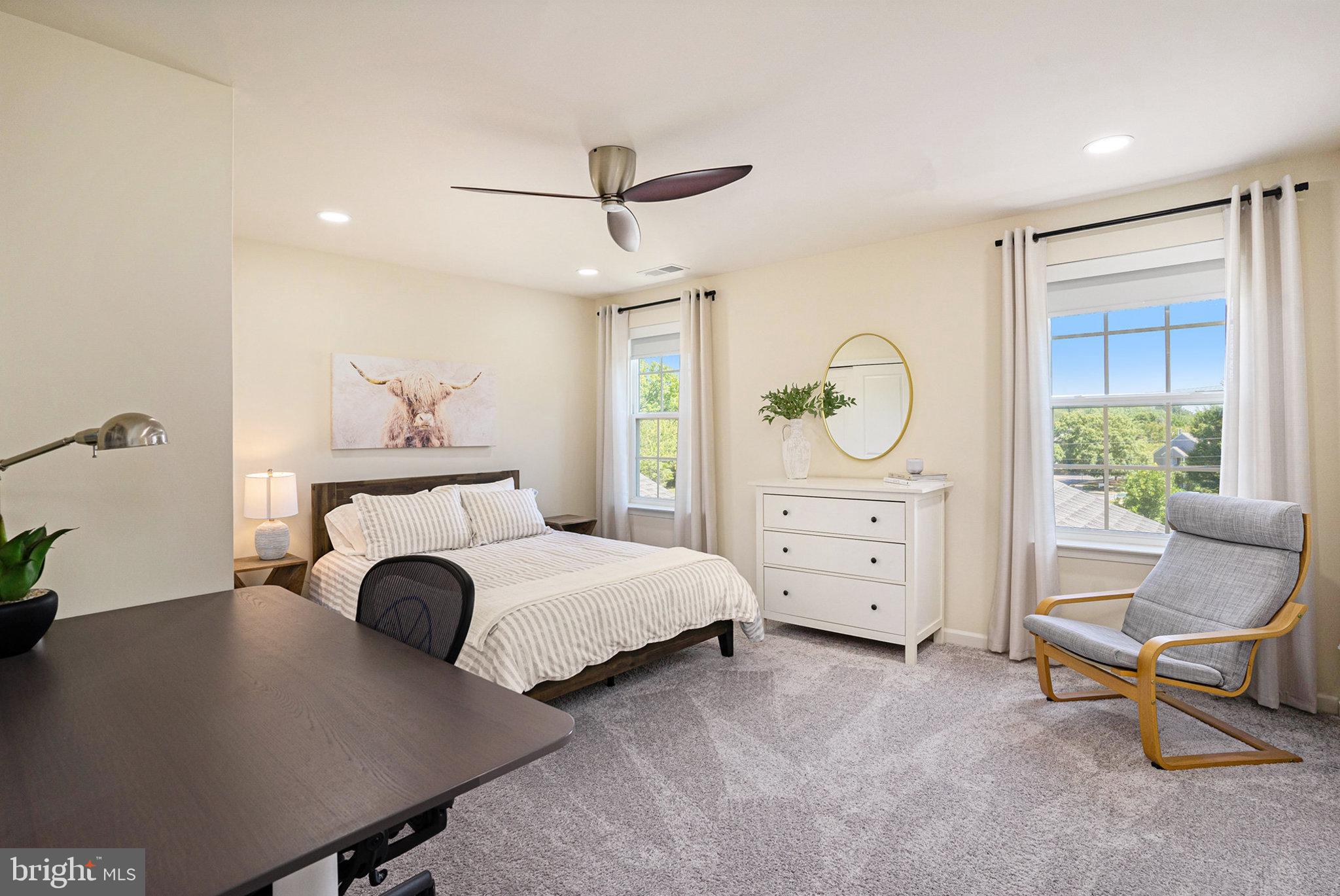 421 Lee Place Exton, PA 19341 - Photo 12 of 58 a spacious bedroom with a bed a table and chair