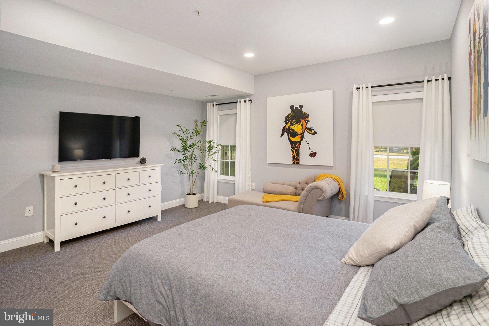 421 Lee Place Exton, PA 19341 - Photo 13 of 58 a spacious bedroom with a bed and a flat screen tv