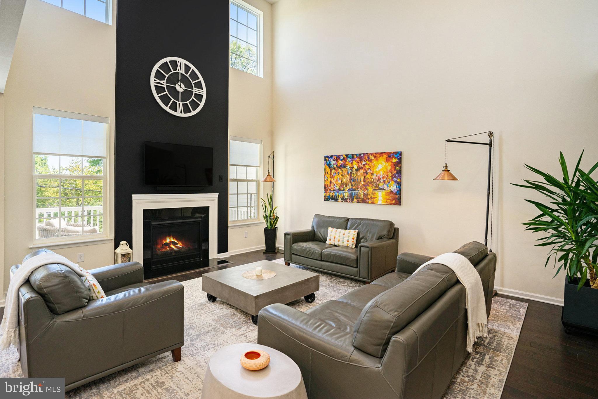 421 Lee Place Exton, PA 19341 - Photo 3 of 58 a living room with furniture a flat screen tv and a fireplace