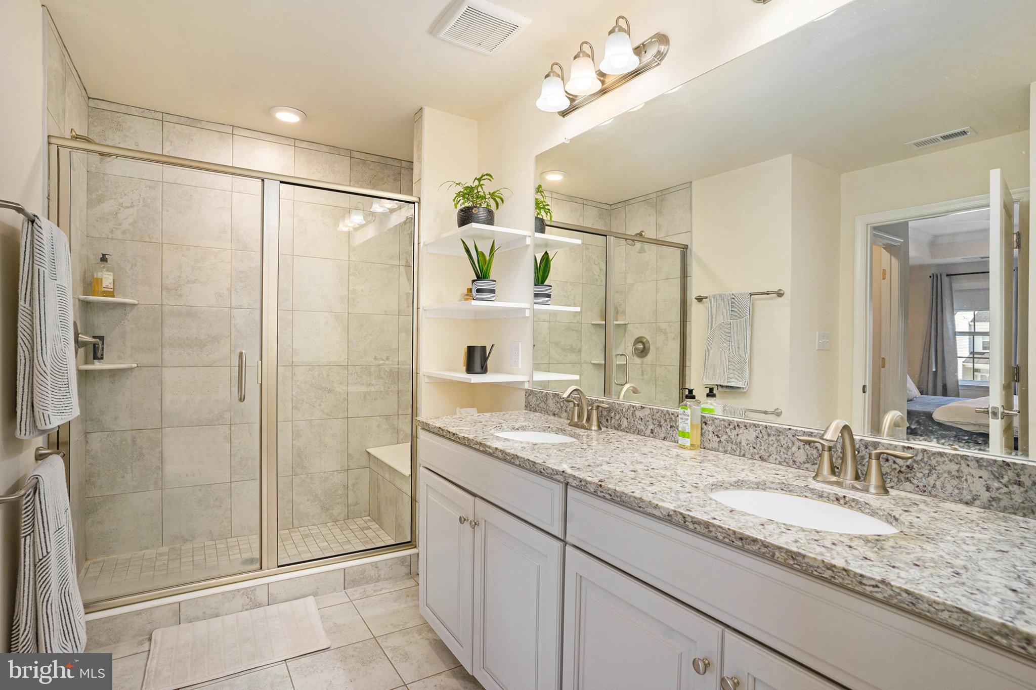 421 Lee Place Exton, PA 19341 - Photo 33 of 58 a bathroom with a granite countertop sink mirror and shower