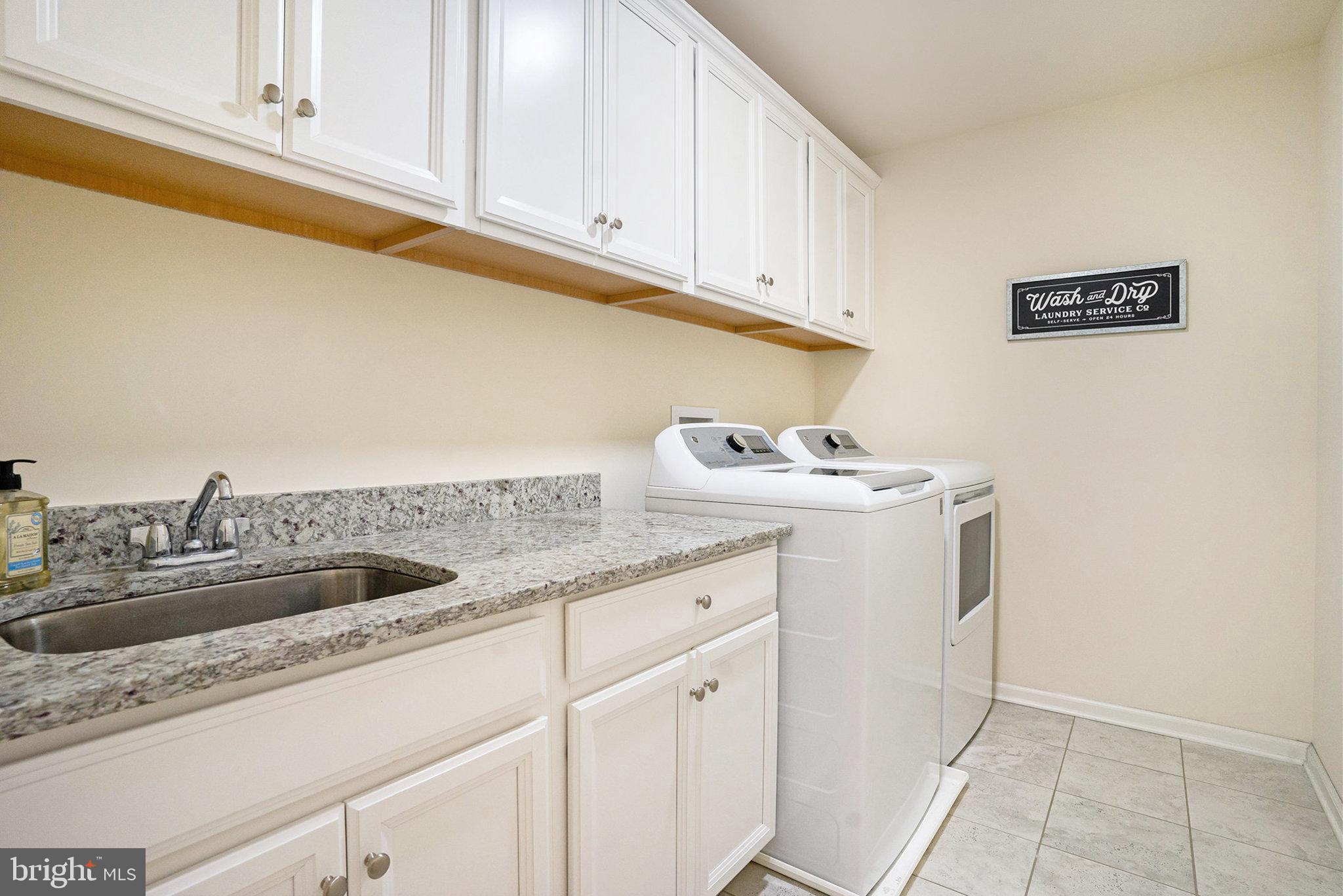 421 Lee Place Exton, PA 19341 - Photo 41 of 58 a kitchen with granite countertop a sink and cabinets