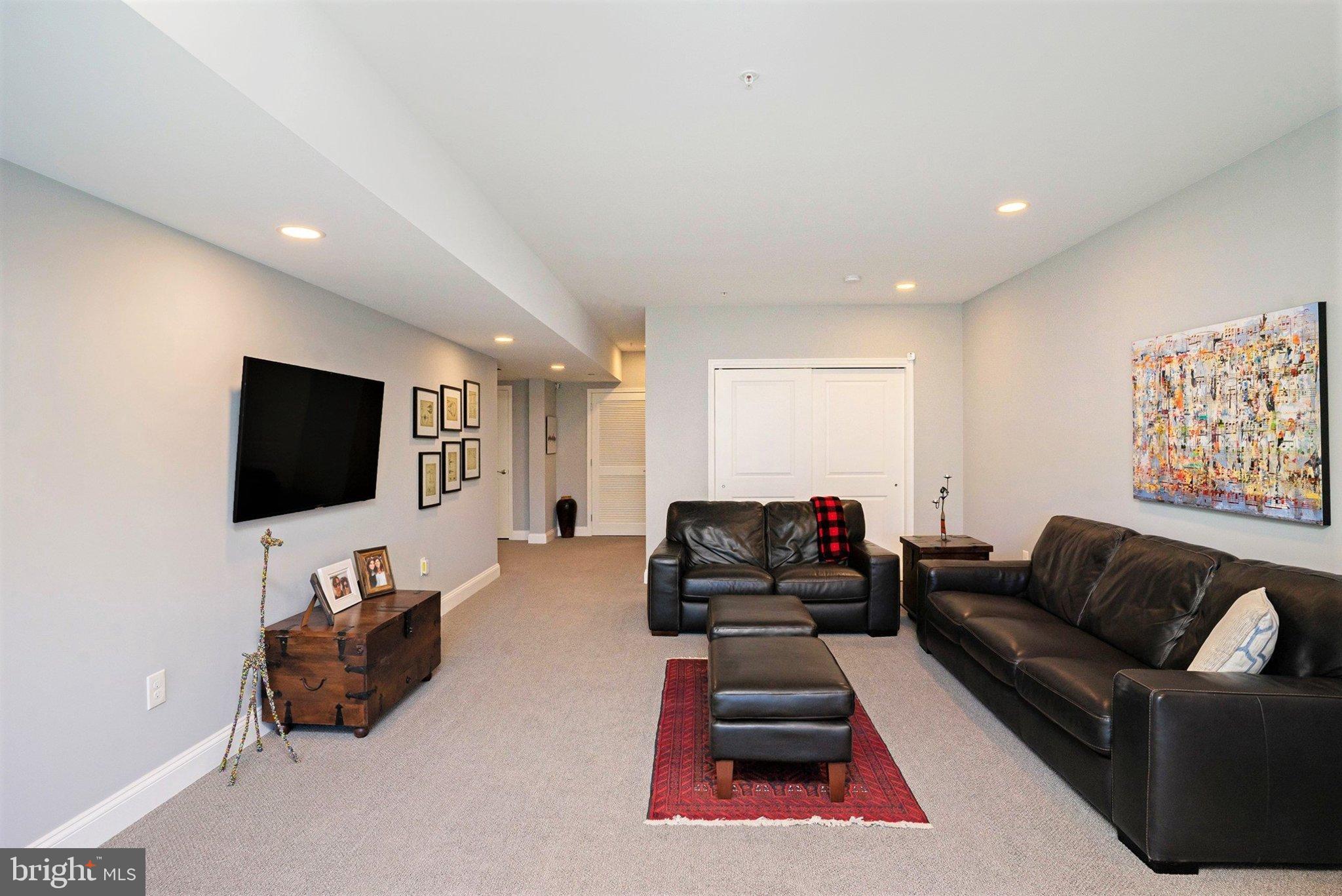421 Lee Place Exton, PA 19341 - Photo 42 of 58 a living room with furniture and a flat screen tv