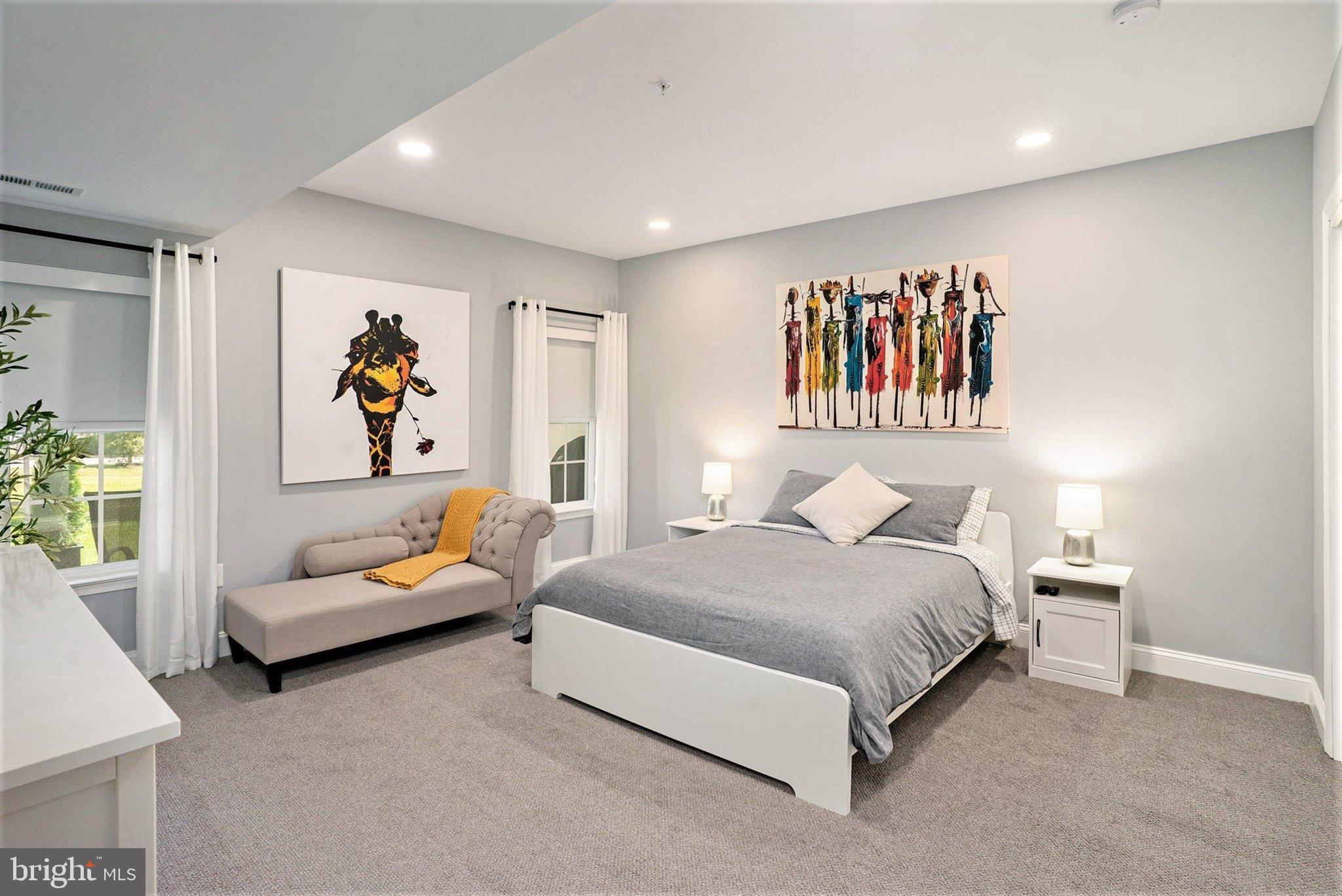 421 Lee Place Exton, PA 19341 - Photo 43 of 58 a spacious bedroom with a bed and a couch