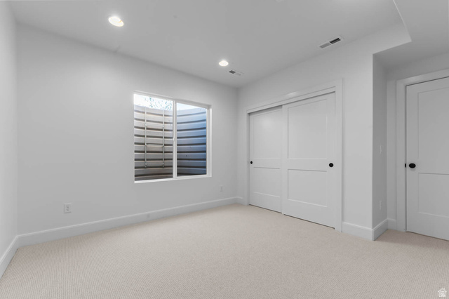 11711 South Halls Crk Road Draper, UT 84020 - Photo 28 of 31 Unfurnished bedroom with light colored carpet, a closet, and recessed lighting