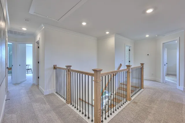 a view of an entryway with a cabinet and mirror