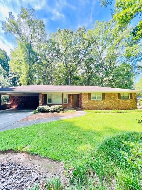 a front view of a house with garden and sitting area