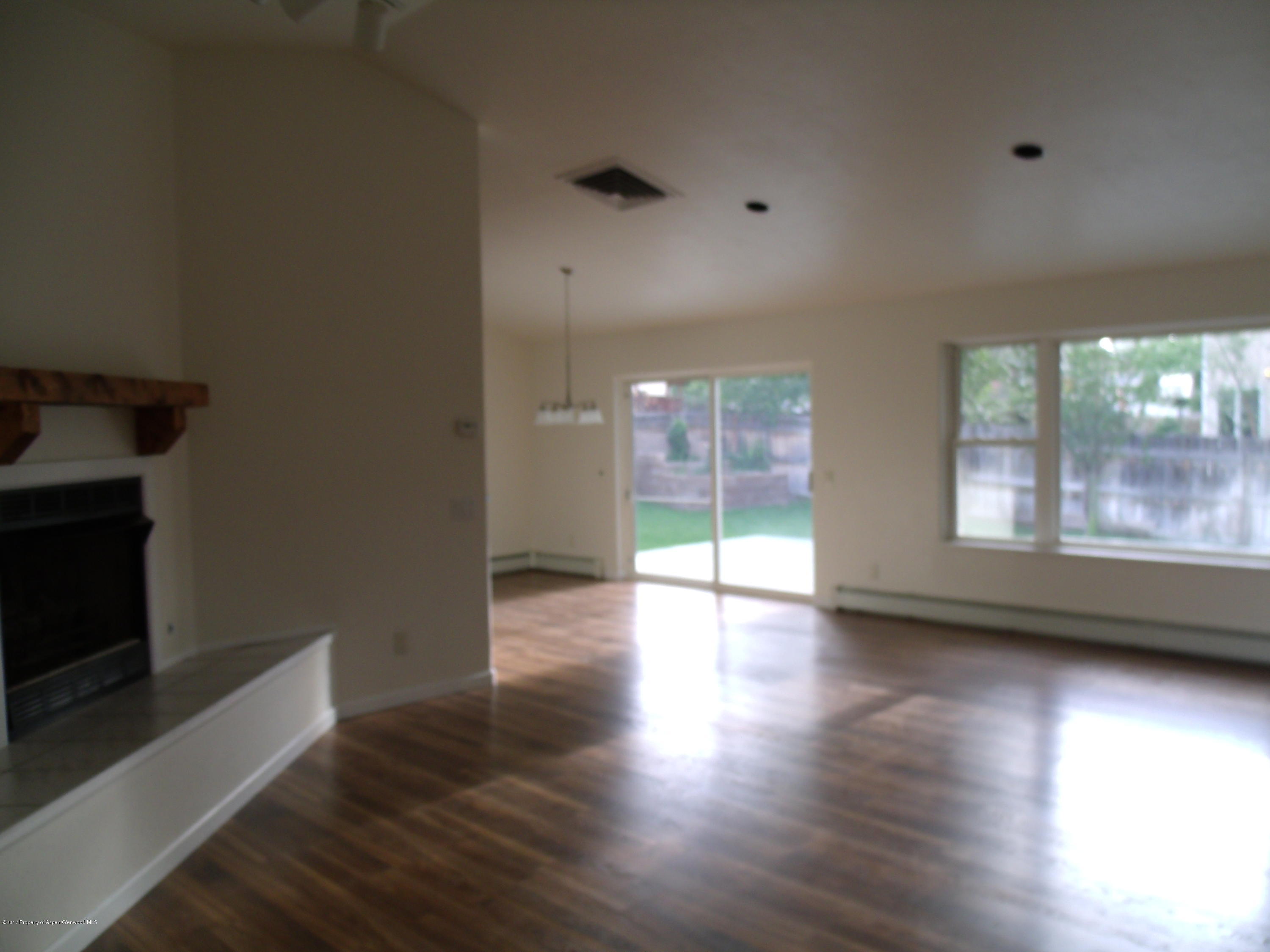 1528 Anvil View Avenue Rifle, CO 81650 - Photo 3 of 20 an empty room with wooden floor and windows